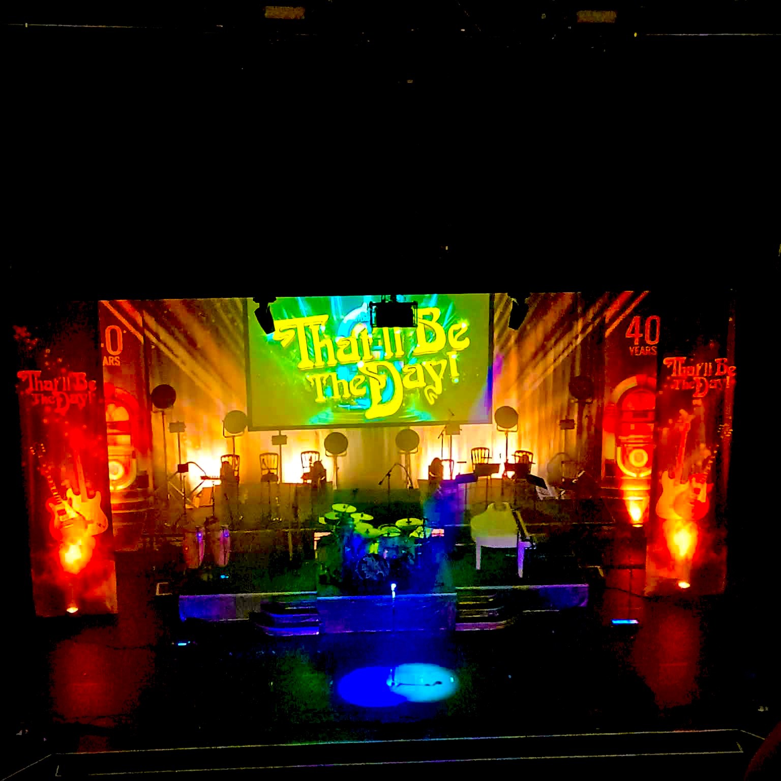 Stage of That'll Be The Day with drum kit and spotlight